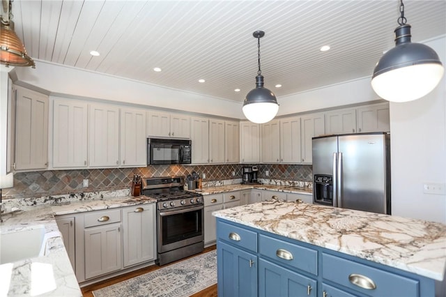 kitchen with appliances with stainless steel finishes, pendant lighting, decorative backsplash, and light stone countertops