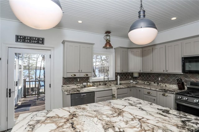 kitchen featuring light stone counters, decorative light fixtures, gray cabinets, a sink, and black appliances