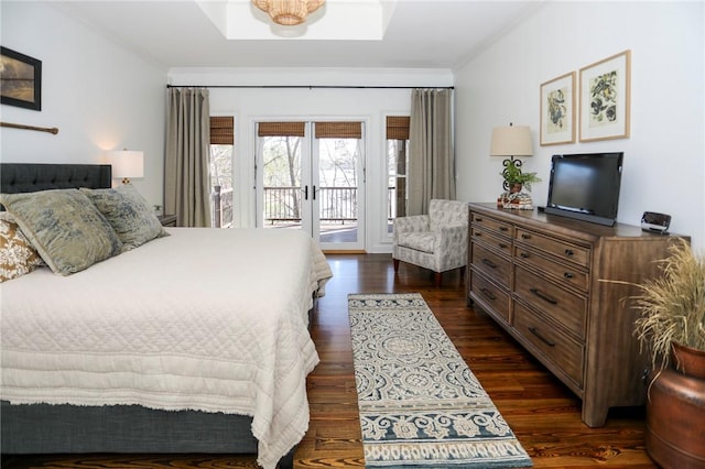 bedroom featuring french doors, ornamental molding, dark wood-style flooring, and access to exterior