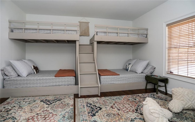 bedroom with baseboards and dark wood finished floors