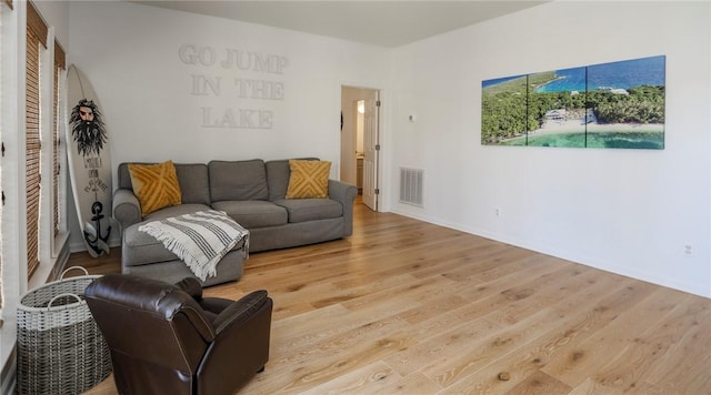 living area with visible vents and light wood-style flooring