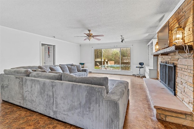 living room with ceiling fan and a textured ceiling