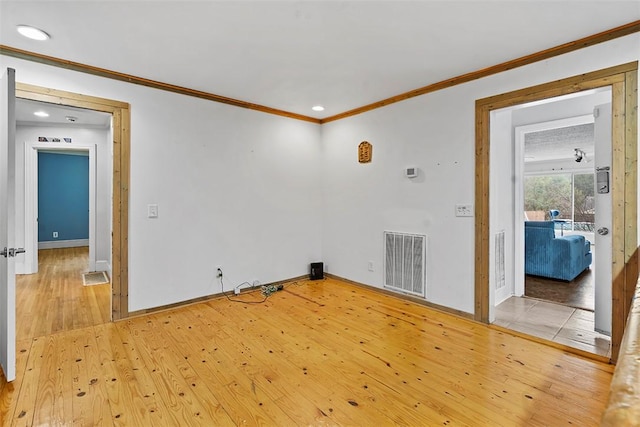 unfurnished room with crown molding and light hardwood / wood-style flooring