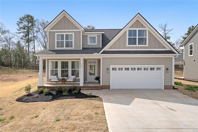 view of front facade featuring board and batten siding, a porch, roof with shingles, a garage, and driveway