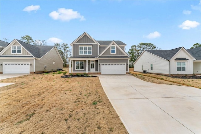 craftsman inspired home featuring central air condition unit, board and batten siding, driveway, and a front yard