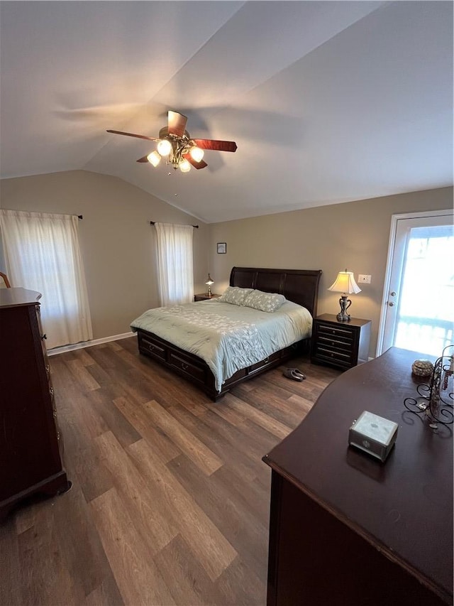 bedroom with ceiling fan, lofted ceiling, and dark hardwood / wood-style flooring