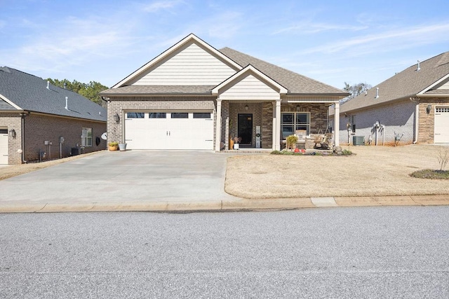 craftsman inspired home with a porch, central air condition unit, and a garage