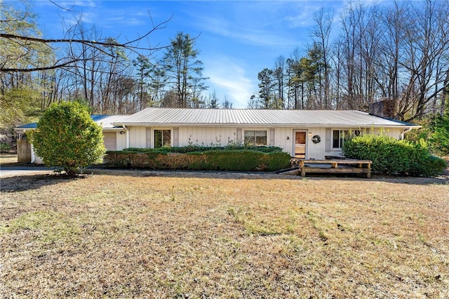 single story home featuring a garage and a front yard