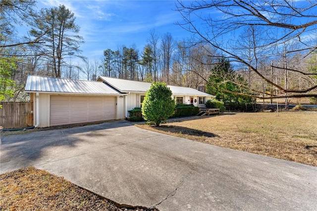 ranch-style home with a garage and a front lawn