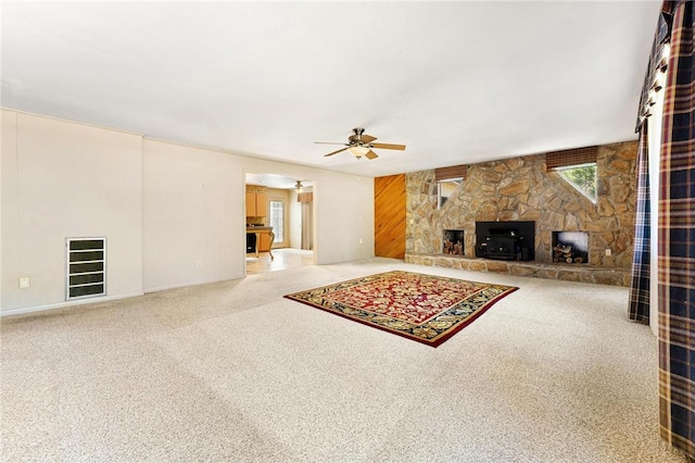 living room featuring ceiling fan, a fireplace, and carpet floors