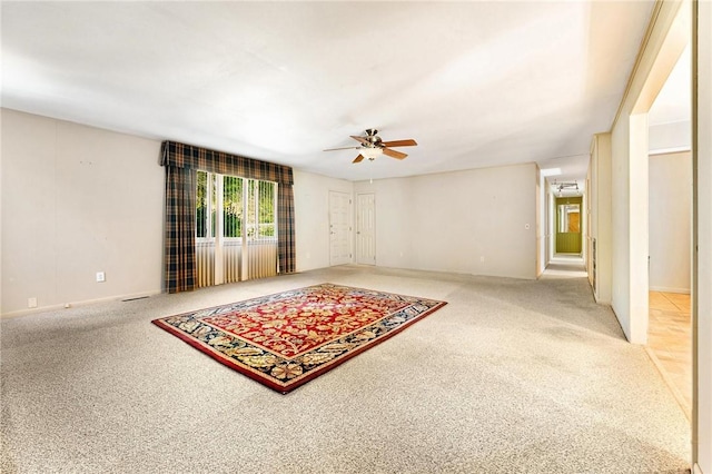 living room with ceiling fan and carpet flooring