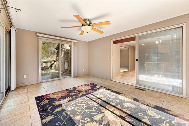 unfurnished bedroom with ceiling fan, light tile patterned floors, and access to outside