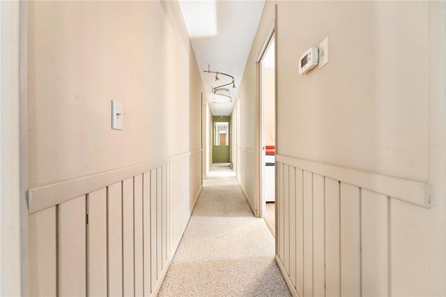 corridor featuring light colored carpet