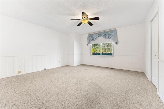 540 Gnats Hollow Rd, Mountain Rest, SC 29664 - empty room with carpet floors, ceiling fan, a wainscoted wall, and a textured ceiling