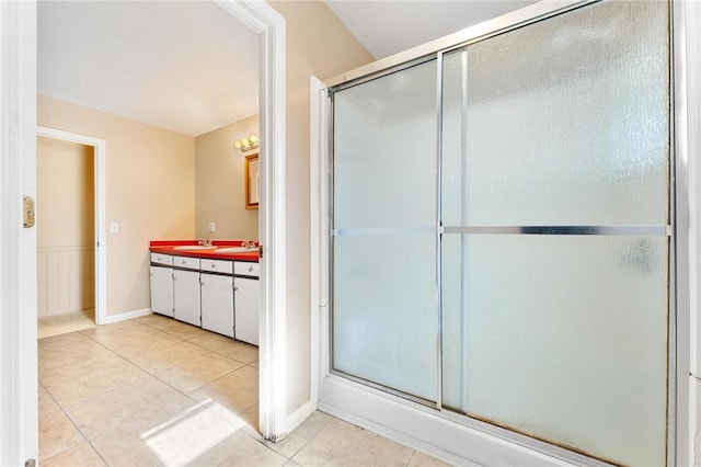 bathroom with vanity, tile patterned flooring, and a shower with door