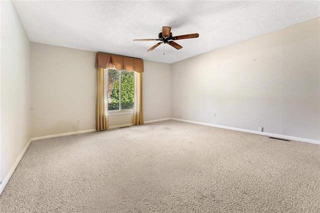 carpeted empty room with a textured ceiling and ceiling fan