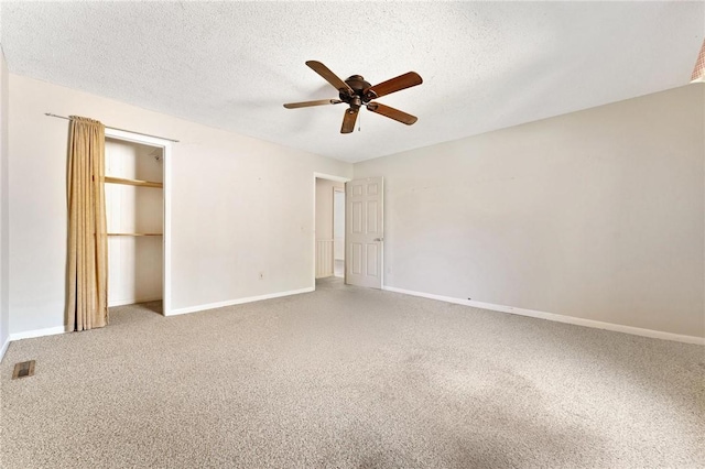 unfurnished bedroom featuring ceiling fan, carpet floors, a textured ceiling, and a closet