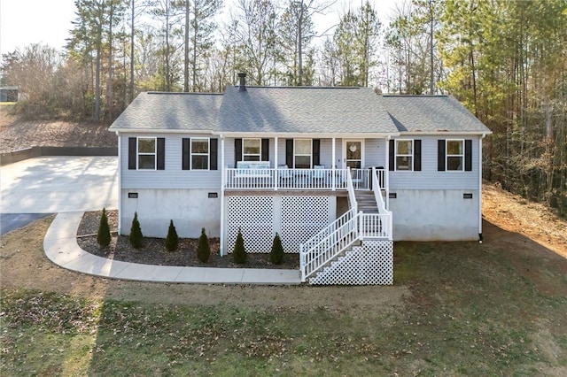 view of front of home with covered porch, driveway, stairway, and roof with shingles