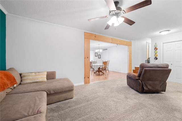 living room featuring ornamental molding, carpet floors, and a textured ceiling