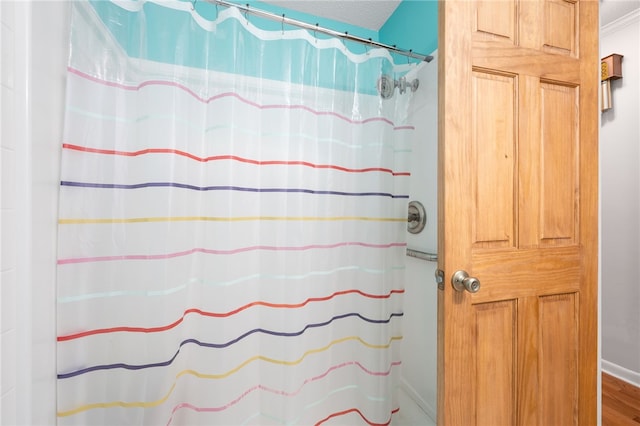 bathroom featuring hardwood / wood-style flooring and a textured ceiling