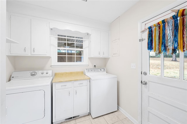 washroom featuring light tile patterned floors, cabinets, and independent washer and dryer