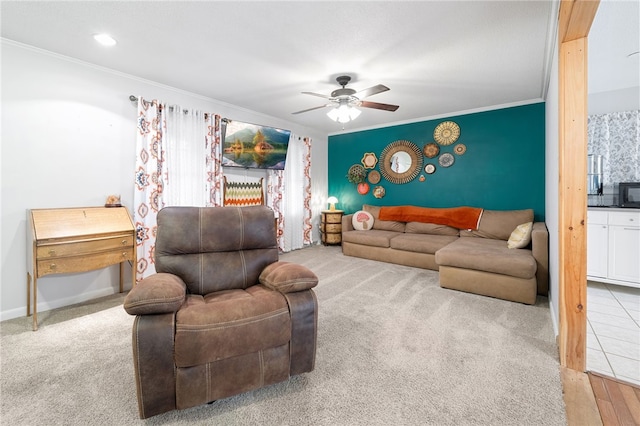 living room with crown molding, light colored carpet, and ceiling fan