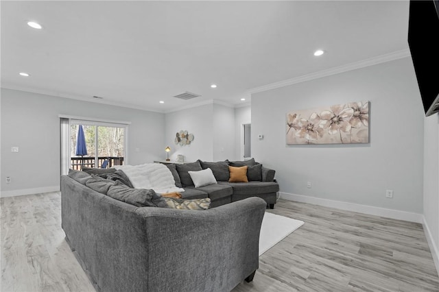 living room with crown molding and light hardwood / wood-style flooring