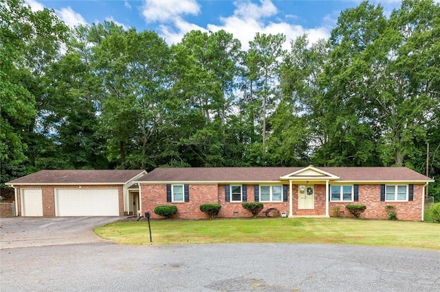 single story home featuring a garage and a front lawn