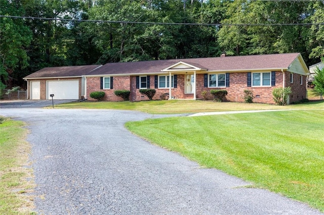 ranch-style house with a garage and a front lawn