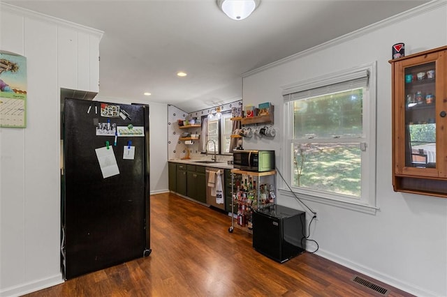 kitchen featuring dark wood-type flooring, appliances with stainless steel finishes, crown molding, and sink