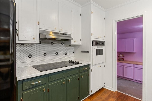 kitchen with crown molding, backsplash, black appliances, white cabinets, and dark hardwood / wood-style flooring