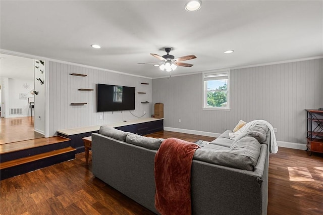 living room with crown molding, dark hardwood / wood-style floors, and ceiling fan