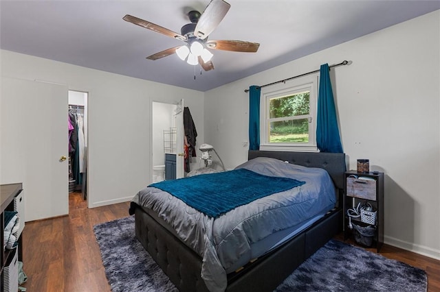 bedroom featuring ensuite bath, ceiling fan, dark hardwood / wood-style floors, a spacious closet, and a closet