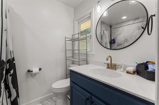 bathroom with vanity, curtained shower, and toilet