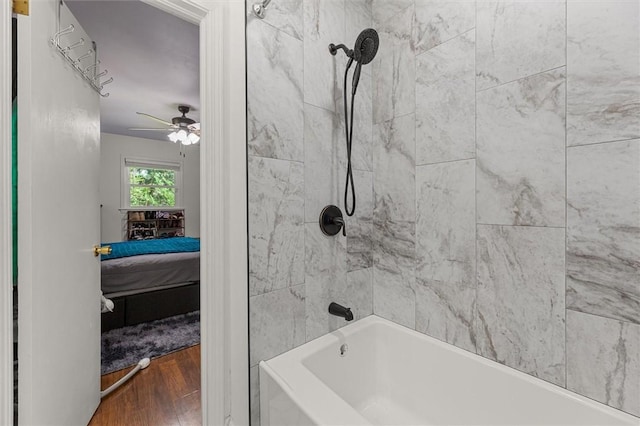 bathroom featuring tiled shower / bath combo, hardwood / wood-style flooring, and ceiling fan