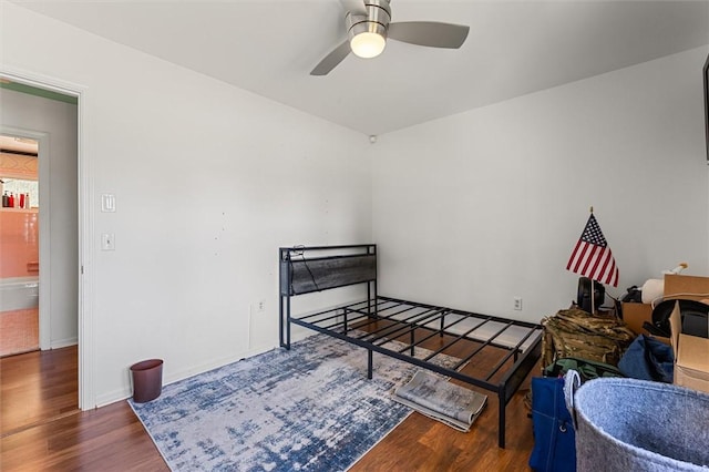 bedroom featuring dark wood-type flooring and ceiling fan