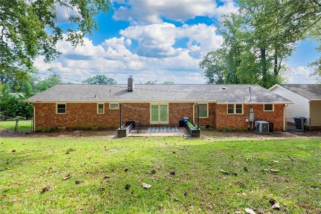 back of house with a yard, central AC unit, and a patio area