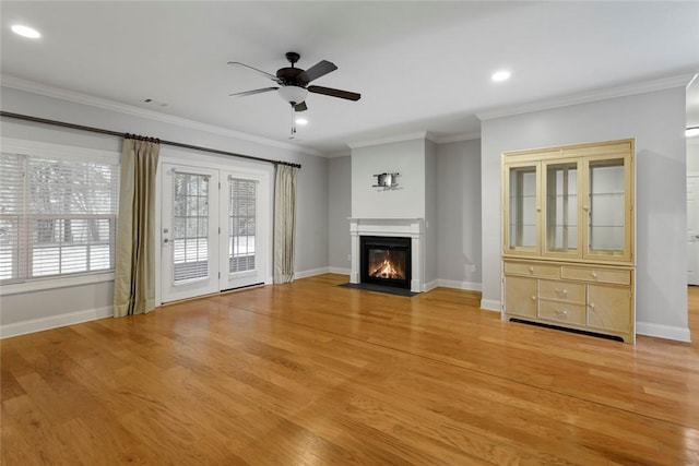 unfurnished living room with ornamental molding, ceiling fan, and light hardwood / wood-style floors