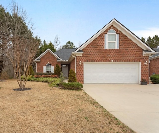 view of property featuring a garage and a front lawn