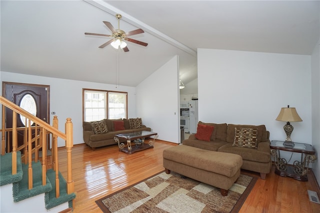 living room featuring hardwood / wood-style flooring, ceiling fan, and lofted ceiling with beams