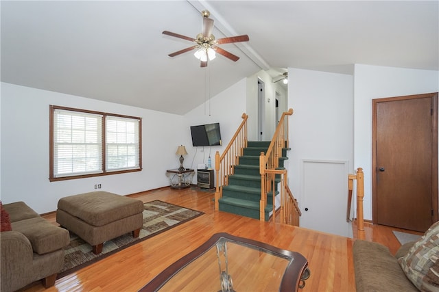 living room featuring vaulted ceiling with beams, ceiling fan, and light hardwood / wood-style flooring