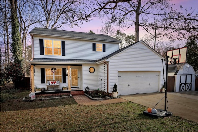 traditional home featuring an outbuilding, a garage, covered porch, concrete driveway, and a shed