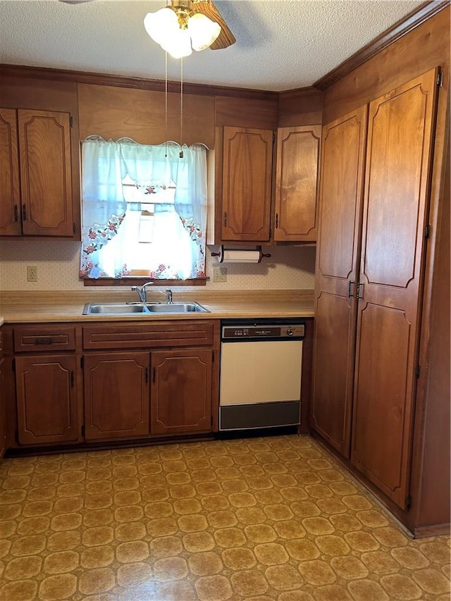 kitchen featuring brown cabinets, light countertops, dishwasher, and a sink