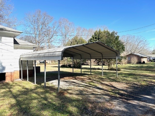 view of vehicle parking featuring a yard and a carport