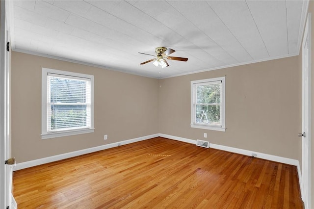 empty room with ceiling fan, ornamental molding, and light hardwood / wood-style floors