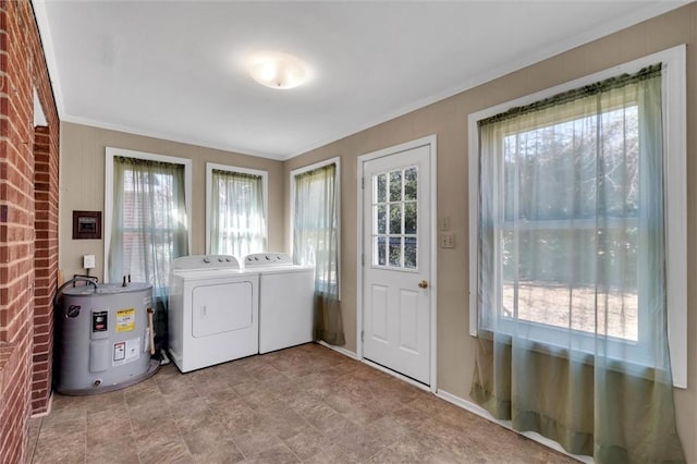 washroom with washer and dryer, water heater, and a healthy amount of sunlight