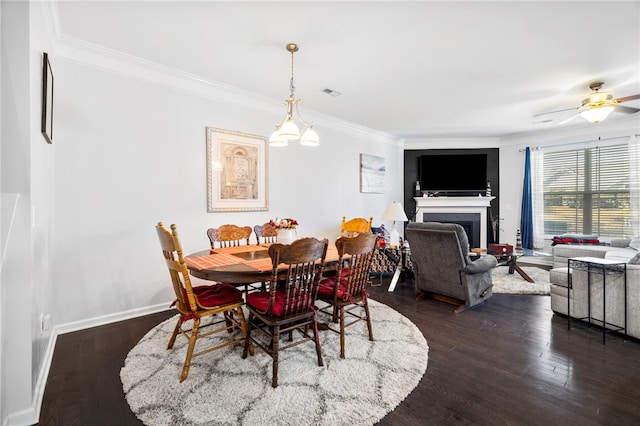 dining room with ceiling fan, dark wood-type flooring, and ornamental molding