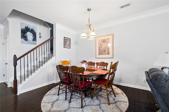 dining area with dark hardwood / wood-style flooring, ornamental molding, and a notable chandelier