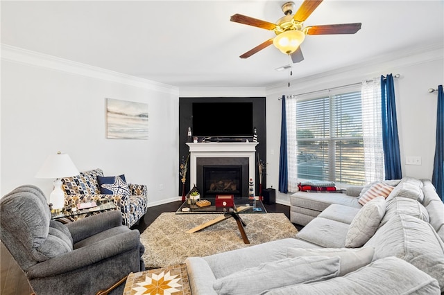 living room featuring hardwood / wood-style flooring, crown molding, and ceiling fan