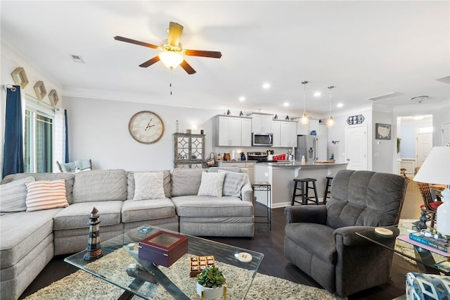 living room featuring ceiling fan, ornamental molding, and dark hardwood / wood-style flooring